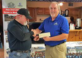 Post Commander Larry Anderson presents a check to Vets Roll Co-Founder Mark Finnegan.