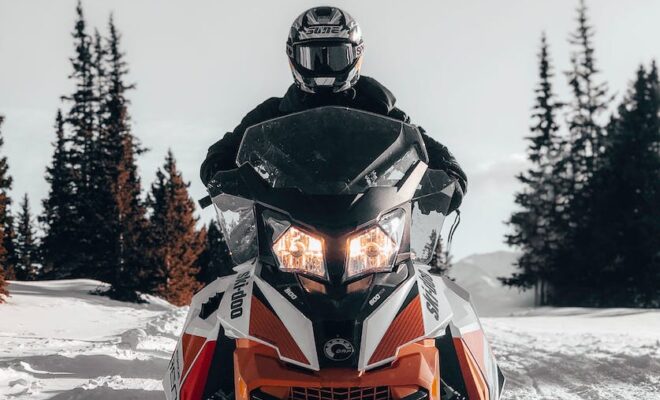 photo of person riding snowmobile